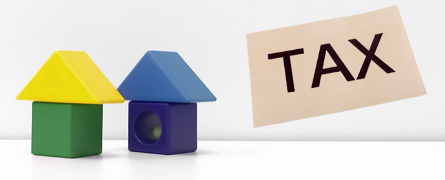 建物模型とTAXの文字により相続税を現したイメージ画像